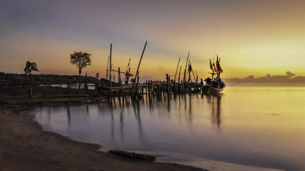 Sunrise scenery with fishing boat at Nakhon Si Thammarat,Thailand